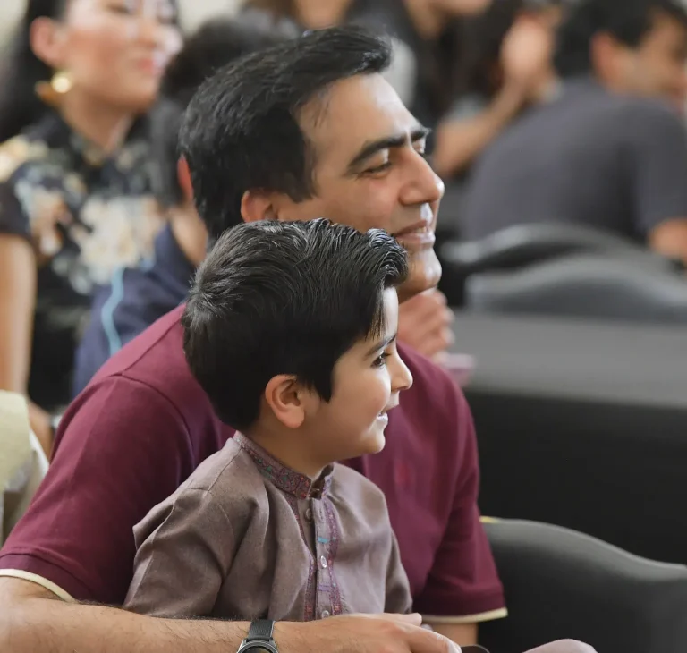 Father and son enjoying event audience.