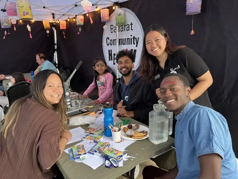 Community event with activities and people smiling.
