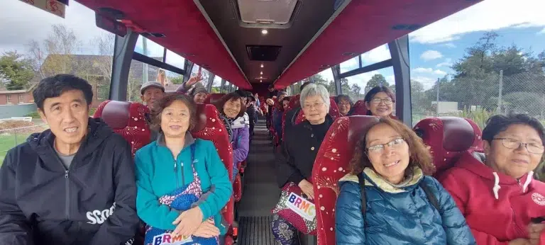 Group of happy seniors on a bus trip.