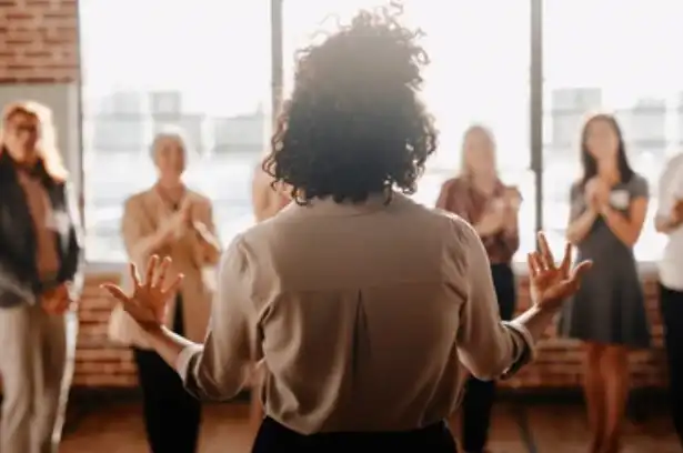 Person leading a group discussion in office.
