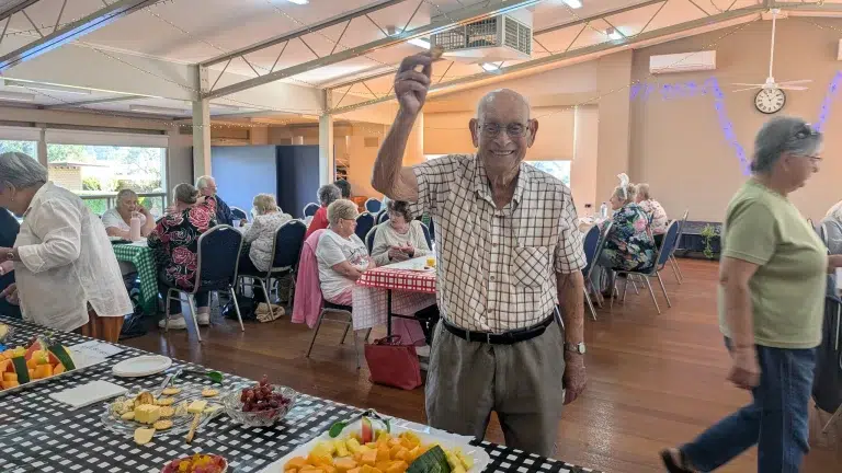 Seniors socialising at community hall Melbourne event.