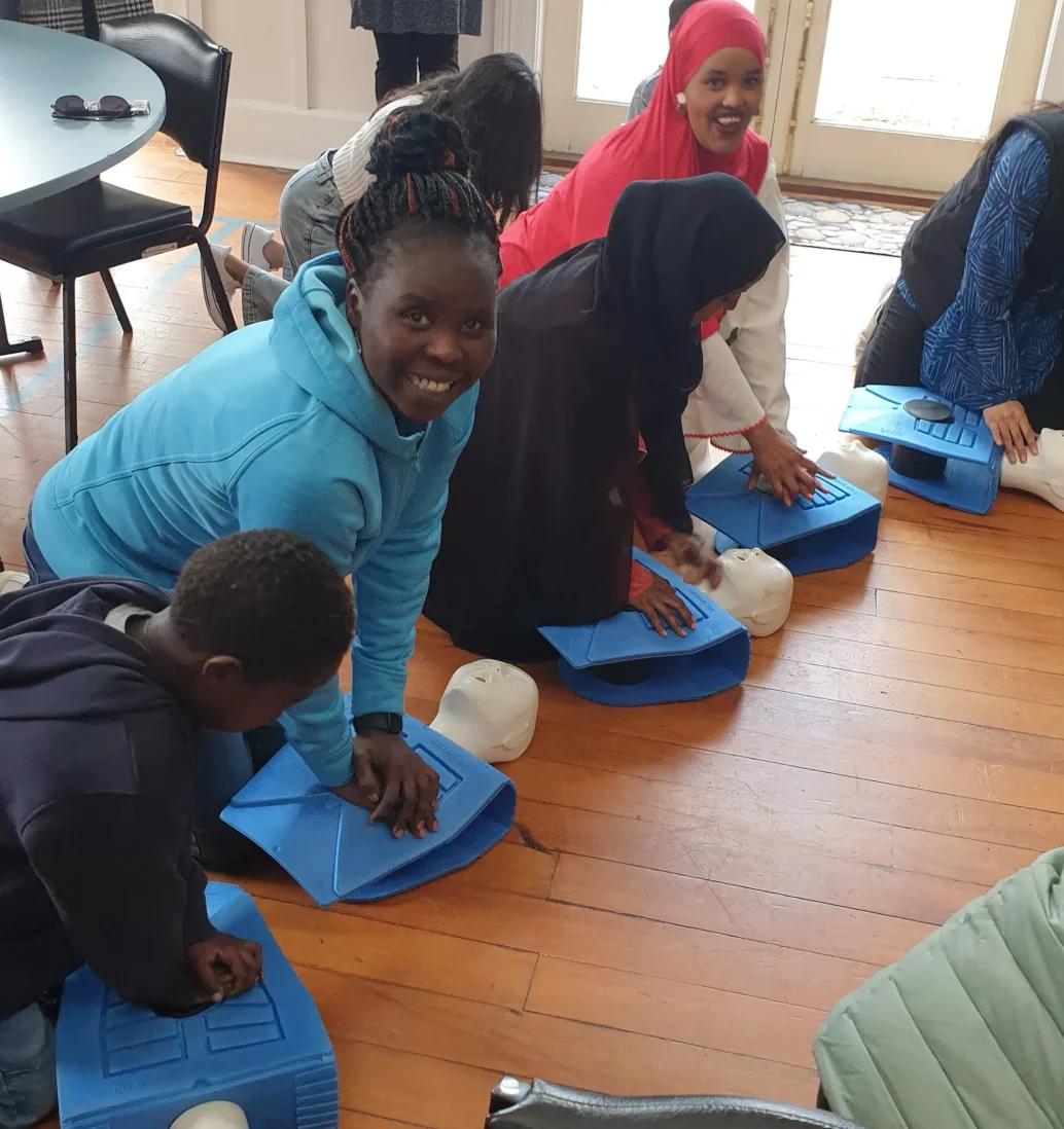 Group practicing CPR on training mannequins.