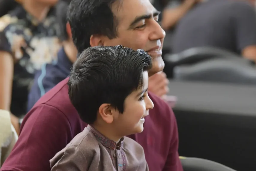 Father and son enjoying event audience.