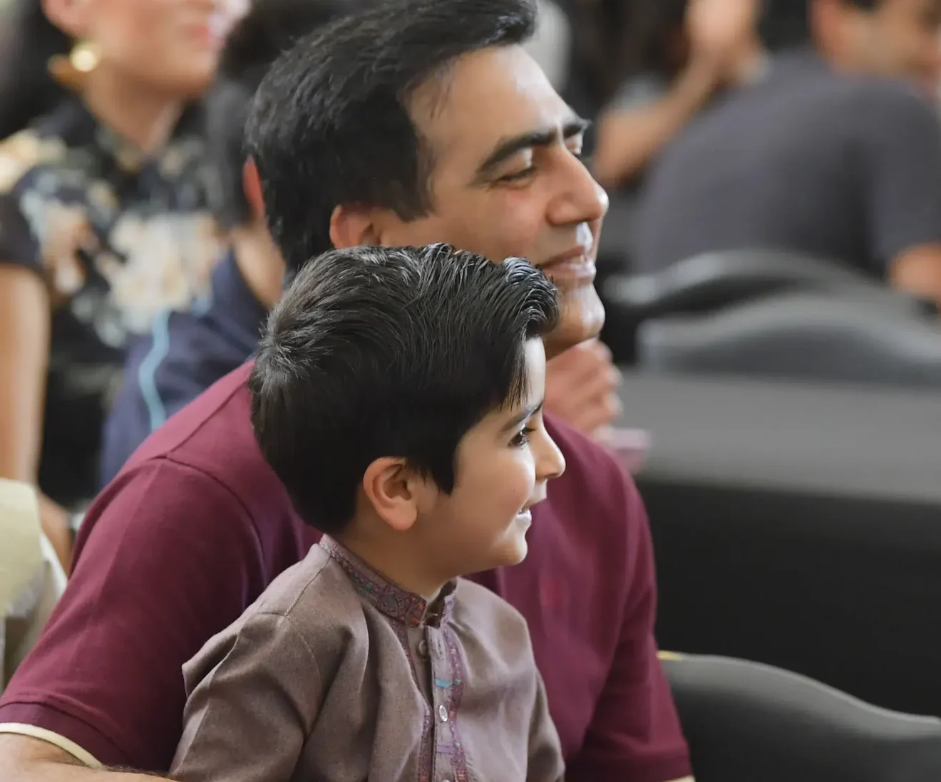 Father and son enjoying event audience.