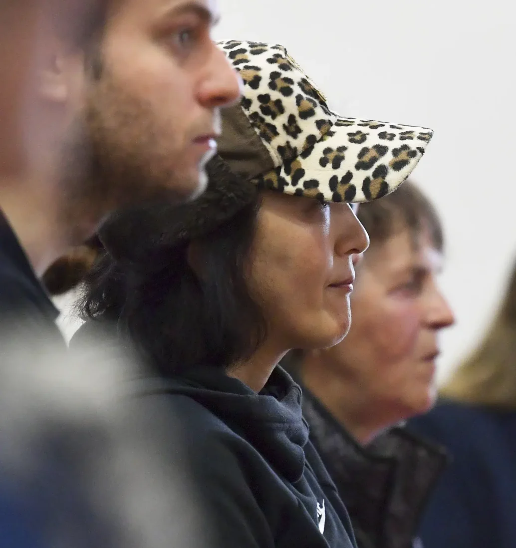 People attending workshop, focus on leopard cap.