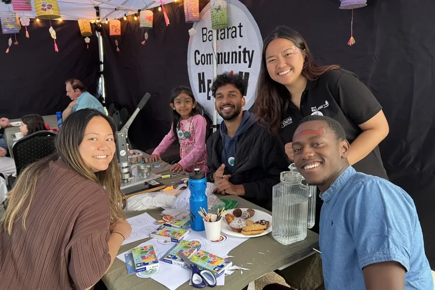 Community event with activities and people smiling.