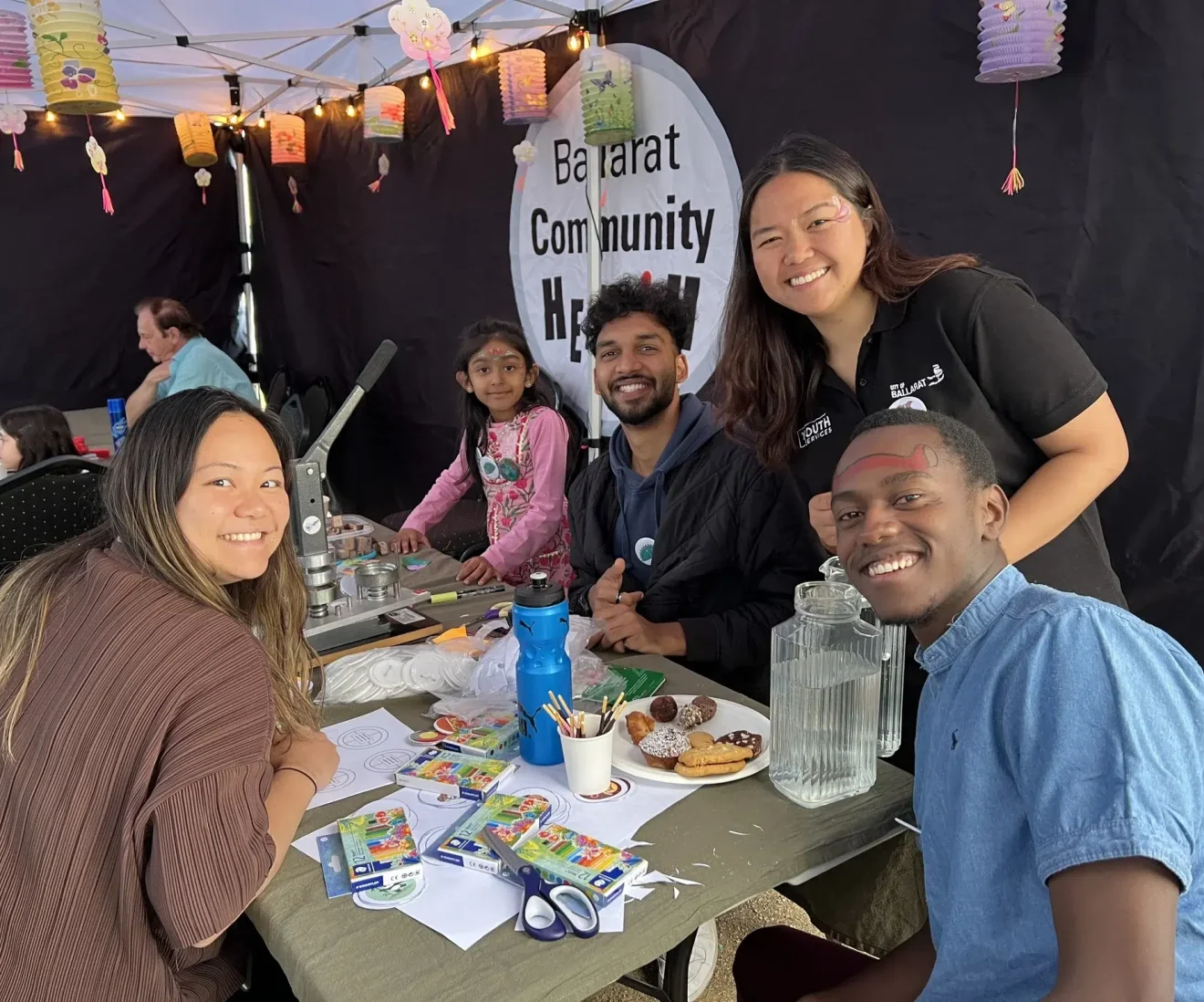 Community event with activities and people smiling.