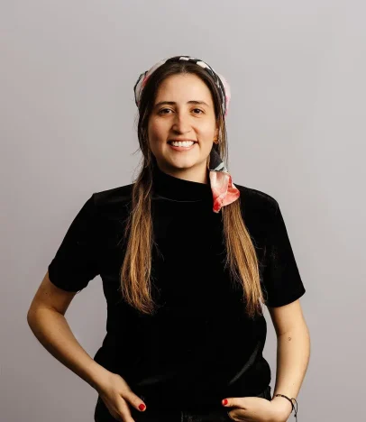 Smiling woman wearing a scarf and black shirt.