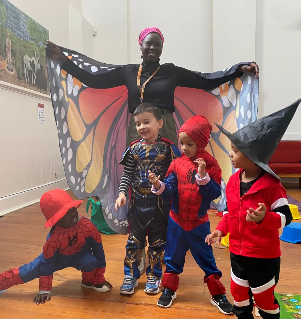 Children in costumes with butterfly wings at daycare.