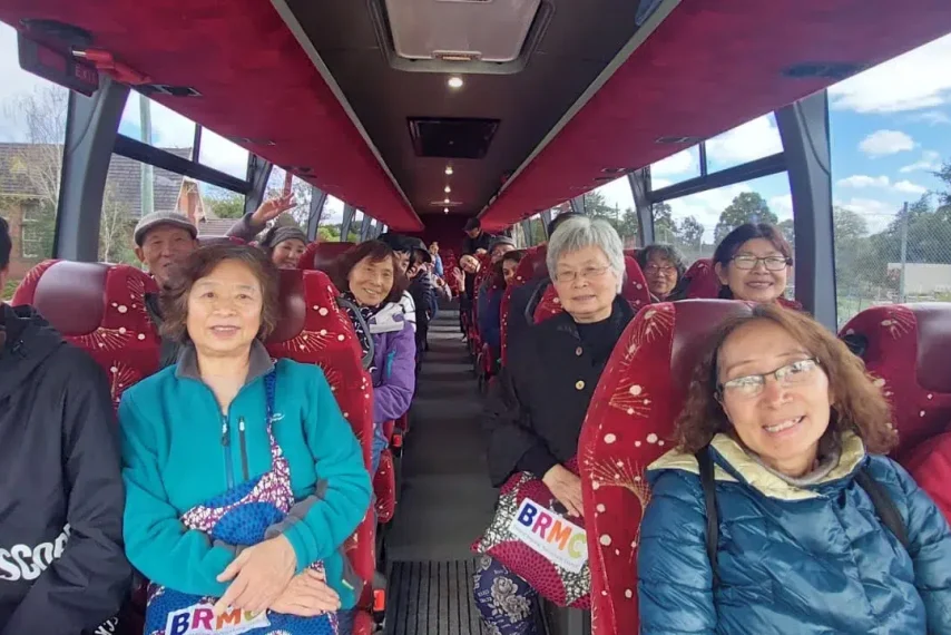 Group of happy seniors on a bus trip.