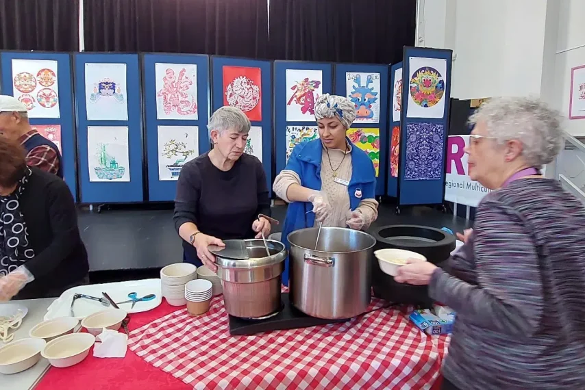 Community event with people preparing noodles.
