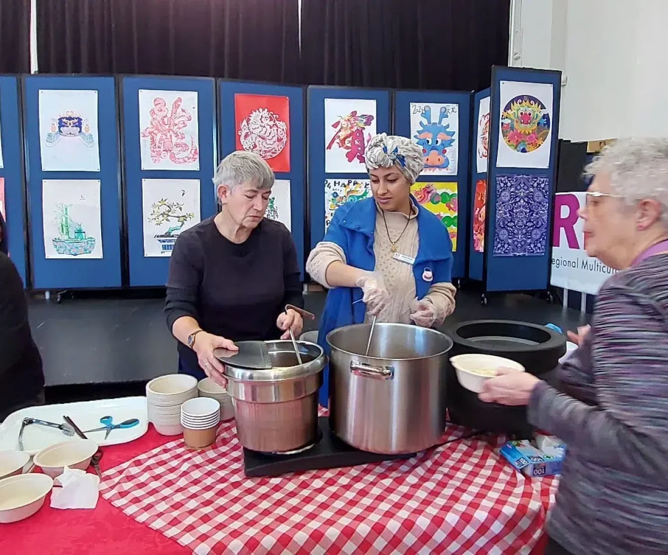 Community event with people preparing noodles.