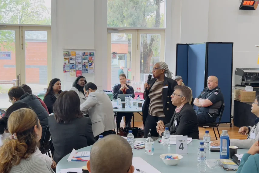 Diverse group meeting in community centre room.