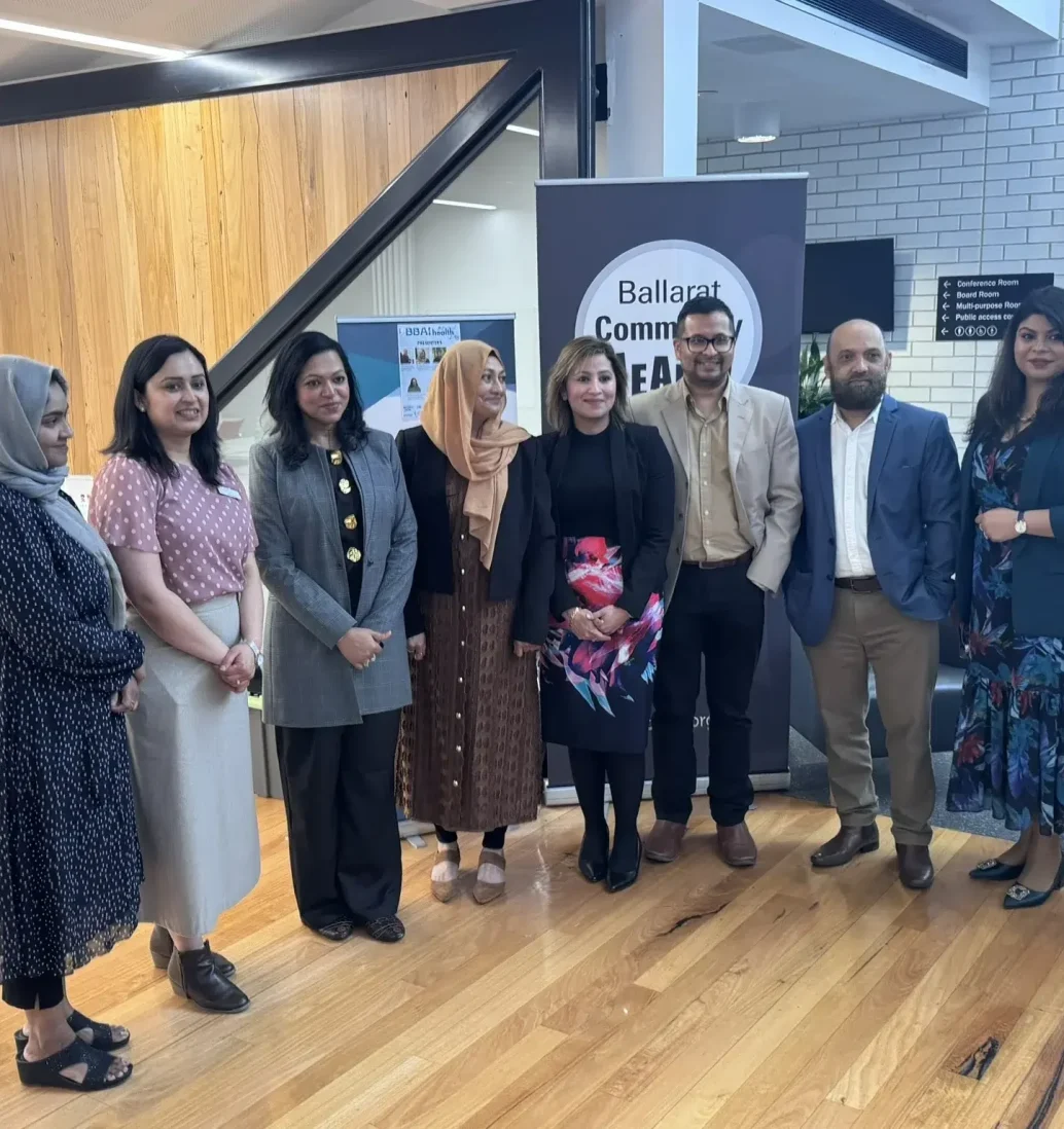 Group of professionals at Ballarat Community event indoors.