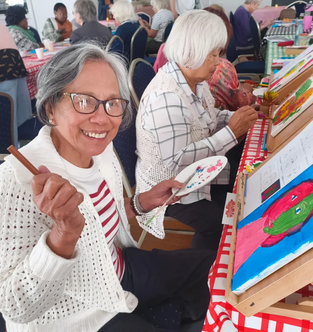 Seniors painting at community art class.