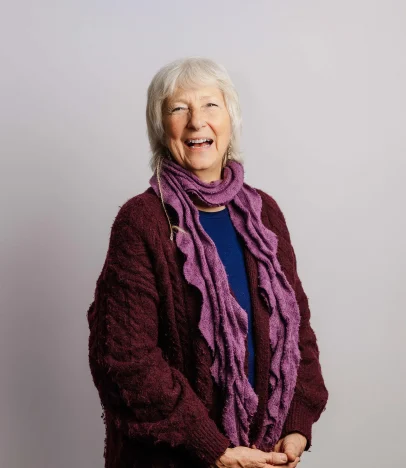 Smiling elderly woman in warm clothing