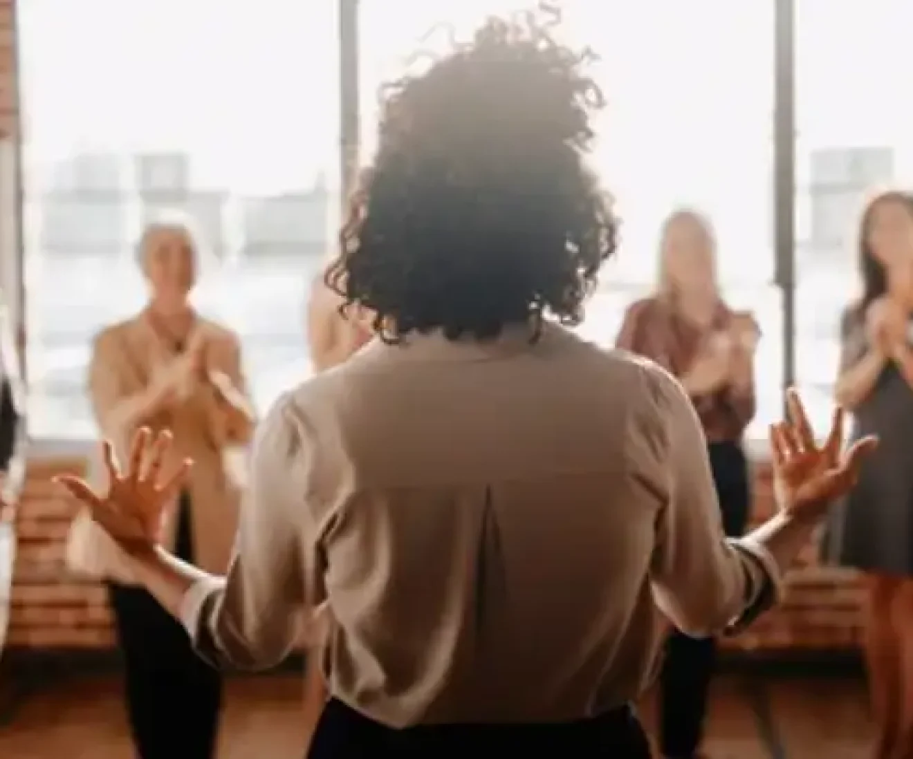 Person leading a group discussion in office.